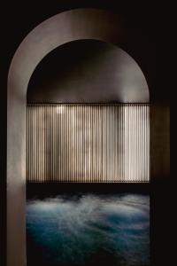 an archway with a painting of a room with water at Experimental Marais in Paris