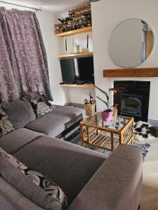 a living room with a couch and a table at House in central winchester in Winchester