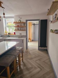 a kitchen with a counter and a table and chairs at House in central winchester in Winchester