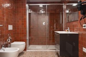 a bathroom with a shower and a toilet and a sink at 20Miglia Albergo Diffuso - Via Giovanni Di Prima in Catania