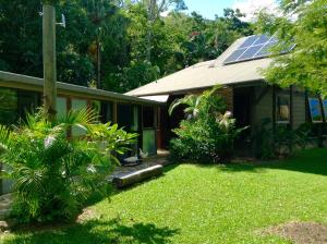 a house with a yard with a solar roof at Butterfly Studio in Proserpine