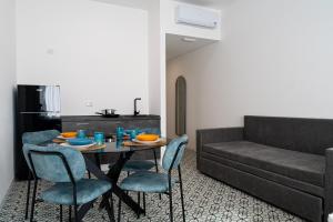 a living room with a table and a couch at 20Miglia Albergo Diffuso - Via Giovanni Di Prima in Catania +56 photos