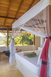 a bedroom with a bed with a canopy at Lake Villa near Udawalawe National Park in Pahalagama