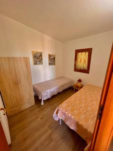 Postel nebo postele na pokoji v ubytování oasi macerina