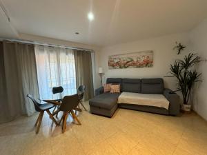a living room with a couch and a table at Parrot’s House in Lloret de Mar