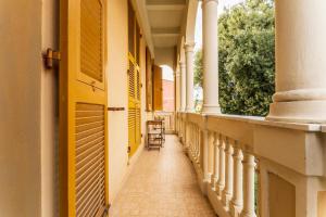 an empty corridor of a building with columns and a chair at Beatrice House, Bogliasco, Sea Access, Ac in Bogliasco