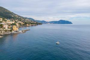 a boat in the middle of a large body of water at Beatrice House, Bogliasco, Sea Access, Ac in Bogliasco