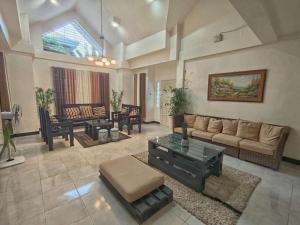 a living room with a couch and a table at Andresas Homestay in Loboc