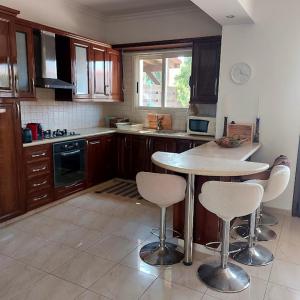 a kitchen with a table and some chairs in it at Danitsea villa with privat pool in Psematismenos