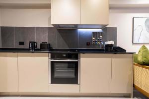 a kitchen with white cabinets and an oven at Verdana Suite - 1BD Flat Near Centre in Manchester