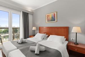 Postel nebo postele na pokoji v ubytování Ariti Grand Hotel