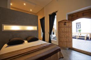 a bedroom with a bed and a large window at Riad Kasbah 117 in Marrakech