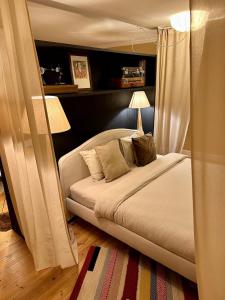 a bedroom with a bed with curtains and a lamp at Old Town St Jacobs Cathedral view in Rīga +11 photos