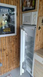 a refrigerator with its door open in a kitchen at Les Troglos de Beaulieu in Loches