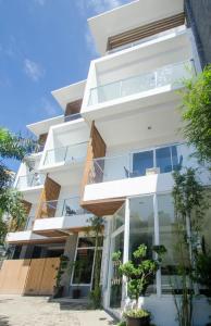 an exterior view of a white building with large windows at Jony's Boutique Hotel in Boracay