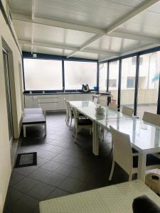 a dining room with a white table and chairs at T3 Aguiar in Vila Pouca de Aguiar