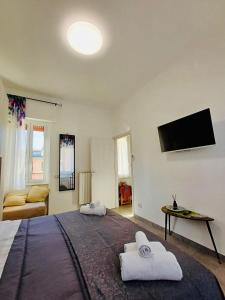 a bedroom with a large bed and a flat screen tv at Tolstoi 83 Apartment in Milan +13 photos