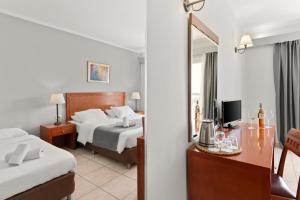 Postel nebo postele na pokoji v ubytování Ariti Grand Hotel