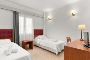 Postel nebo postele na pokoji v ubytování Ariti Grand Hotel
