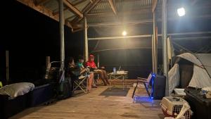 a group of people sitting in a room at night at GME's Little Farm in Pililla