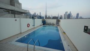 a large swimming pool on the roof of a building at 1BHK full canal view apartment in Business bay ! in Dubai