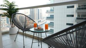a table with a plate of food on a balcony at 1BHK full canal view apartment in Business bay ! in Dubai