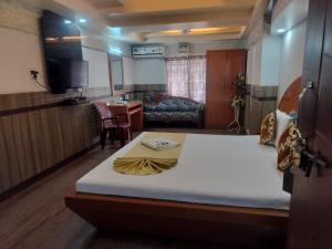 a bedroom with a large bed in a room at Hotel Nagaon Point in Nowgong
