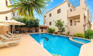 a swimming pool in front of a building at Ferienhaus Für 28 Personen In Skaleta, Kreta Nordküste Kretas in Skaleta