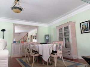 a dining room with a table and chairs and a mirror at Casa Rua dos Loureiros in Marco de Canaveses