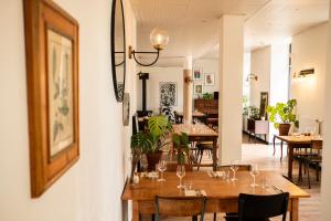a dining room with wooden tables and chairs at L'Auberge du Campos in Saint-Pierre-Duchamp +21 photos