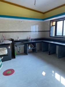 an empty kitchen with a sink and a window at Mangal Murti Family home stay in Alibaug