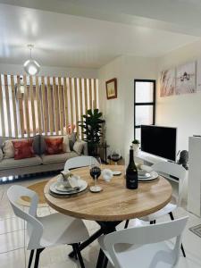 a living room with a wooden table and white chairs at Dani House - Porto Moniz Escape in Porto Moniz +10 photos