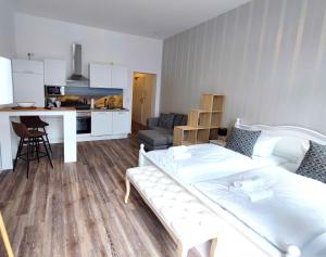 a living room with a bed and a kitchen at Villa Boberg Apartments in Koserow