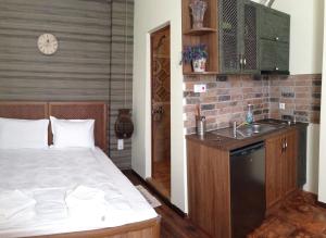a bedroom with a bed and a sink and a counter at Guest Rooms Maria Luiza in Varna City