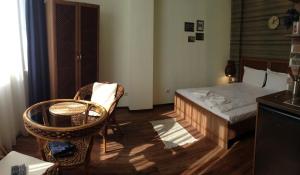 a small bedroom with a bed and a chair at Guest Rooms Maria Luiza in Varna City