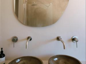 a bathroom with two sinks and a mirror at Kokon Boutique Guesthouse in Somerset West +13 photos