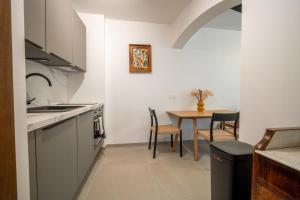 a kitchen with a table and a dining room at Maison alsacienne in Sélestat