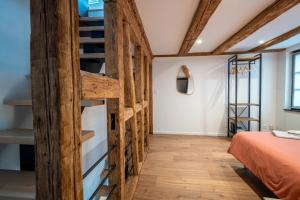 a room with a bed and a wooden staircase at Maison alsacienne in Sélestat +18 photos