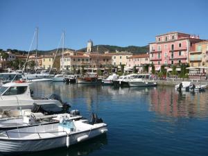 a group of boats docked in a harbor with buildings at Casa Martina a Porto Azzurro in Porto Azzurro