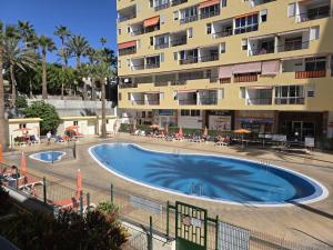 a large swimming pool in front of a building at Joy and Friends 2 El Carmen in Los Cristianos