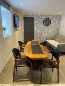 a dining room with a table and chairs and a couch at Warm home in Madonne-et-Lamarey