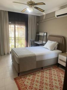 a bedroom with a large bed and a table at Villa Lavanta Marmaris Daily Weekly Rentals in Marmaris