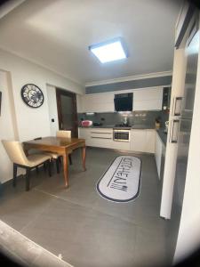 a kitchen with a wooden table and a table and a table and a kitchenestamp at Villa Lavanta Marmaris Daily Weekly Rentals in Marmaris