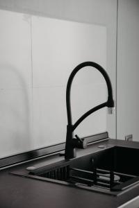 a kitchen counter with a sink with a faucet at Апарт-отель Tong Marina in Tong +122 photos