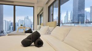 a bedroom with a white bed with teddy bears on it at Skyview Bukit Bintang Fairlane Residence #24 in Kuala Lumpur +114 photos