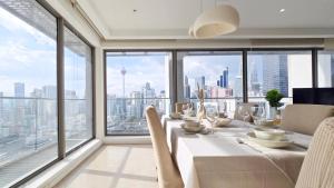 a dining room with a table with a view of the city at Skyview Bukit Bintang Fairlane Residence #24 in Kuala Lumpur