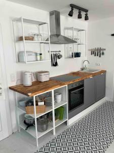 a kitchen with a counter with a sink and a stove at Cozy Apartment In Old Pfarrhaus in Zweikirchen
