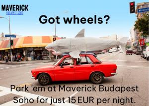 a red car with a surfboard on top of it at Maverick Budapest Soho in Budapest