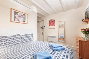 a bedroom with a bed with blue towels on it at Discovery House in Whitby