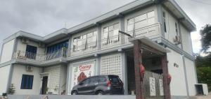a car parked in front of a building at Daeng Homestay in Pangururan